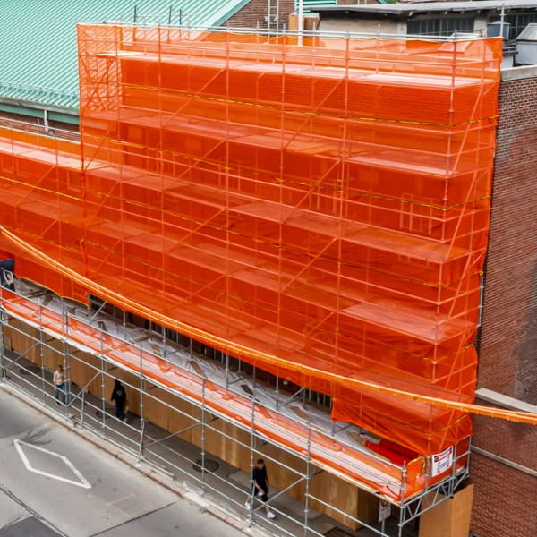 Scafnet.ca Scafnet orange mesh installed on an entire building.