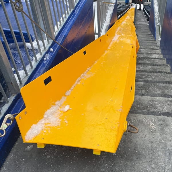 SnoSlides.ca Moving snow from the upper levels in a stadium using a Superchute a snow slide.